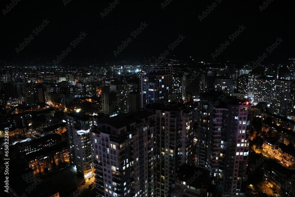 Picturesque view of city with buildings at night Picturesque view of city with buildings at night