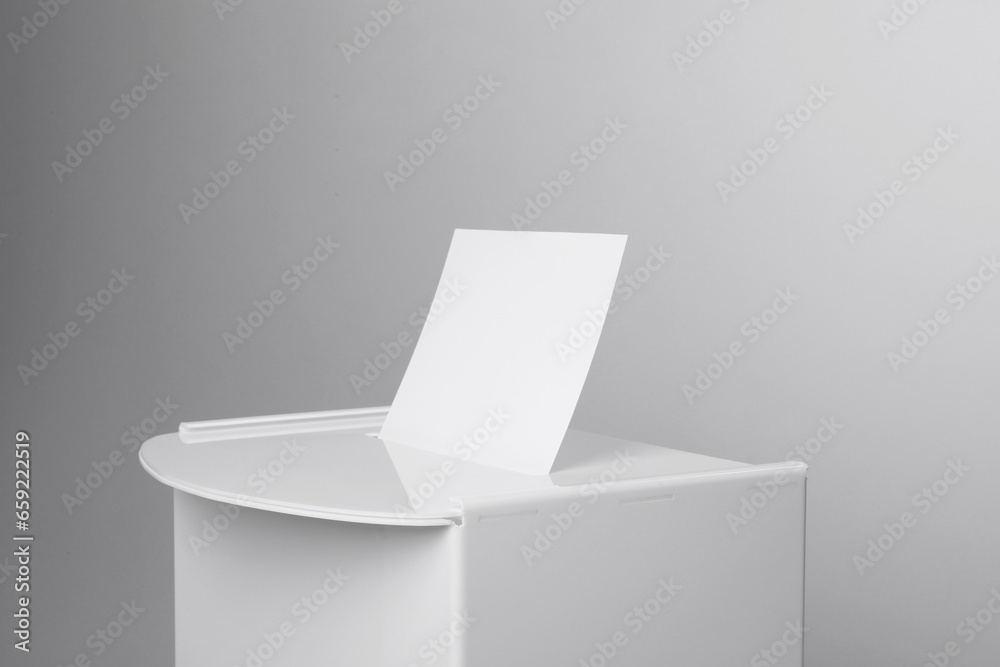 Ballot box with vote on light grey background, closeup. Election time Ballot box with vote on light grey background, closeup. Election time