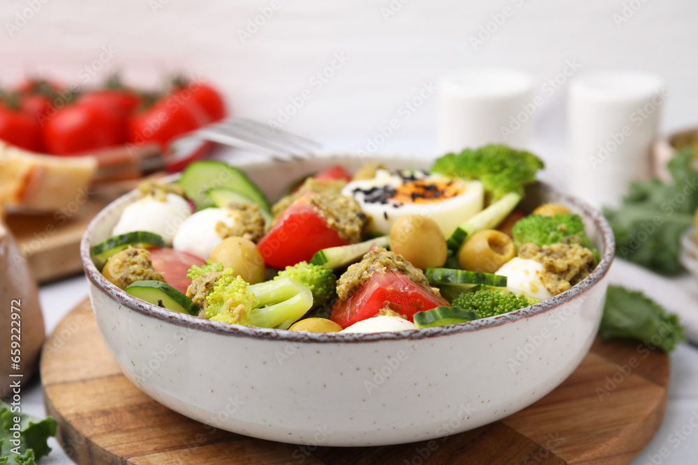 Delicious salad with pesto sauce in bowl on table, closeup Delicious salad with pesto sauce in bowl on table, closeup