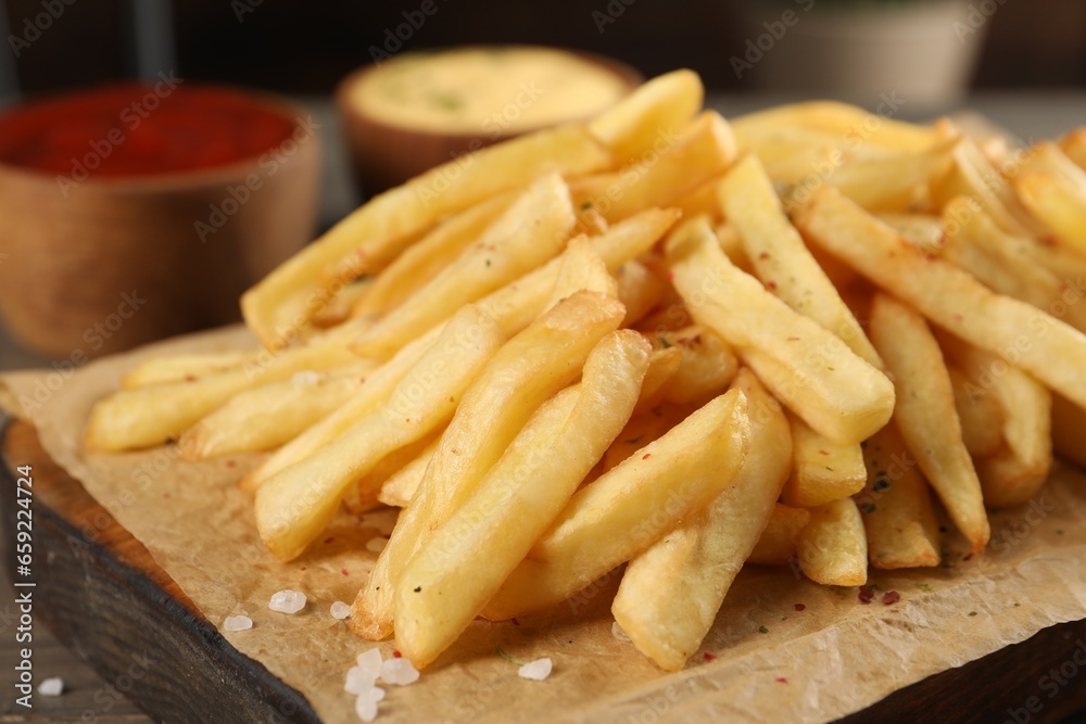 Delicious french fries on board, closeup view Delicious french fries on board, closeup view