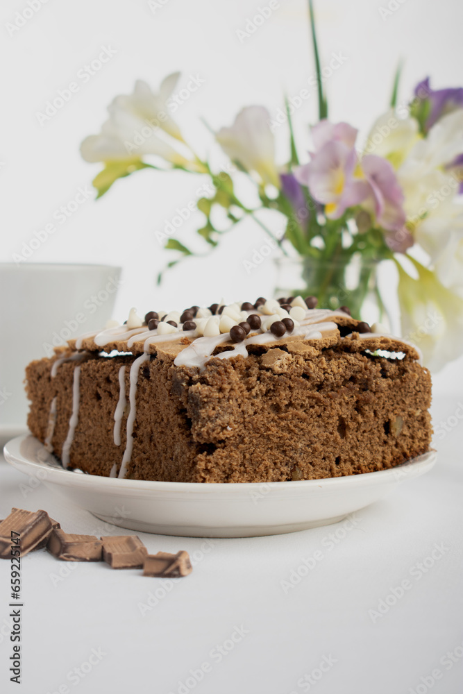 chocolate cake with whipped cream and chocolate chips on a white background chocolate cake with whipped cream and chocolate chips on a white background
