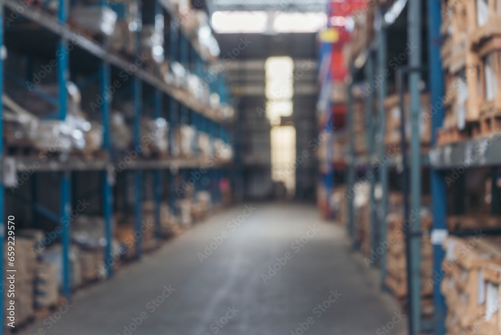 Blurred Background Commercial packaging on steel rack. Aisle in storehouse inventory. Warehouse background storage inventory shelf with freight container aisle space. Blur supply lot shelf cardboard