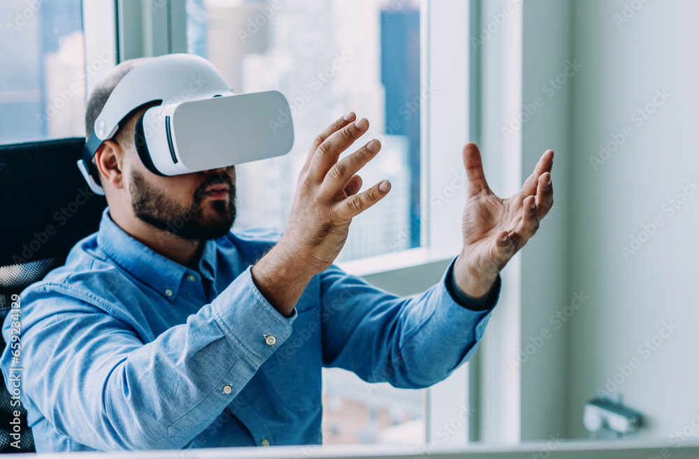 Businessman using VR goggles in office Businessman using VR goggles in office
