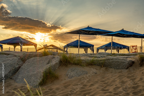Sunrise image of sunlight passing through beach cabanas on Block Island, RI. 