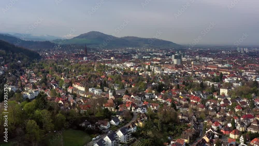 Drone shot, drone photo, drone flight, of the old town, city centre Freiburg im Breisgau with view of the cathedral and mountains, morning light, Neuburg, Baden-Wuerttemberg, Germany, Europe Drone shot, drone photo, drone flight, of the old town, city centre Freiburg im Breisgau with view of the cathedral and mountains, morning light, Neuburg, Baden-Wuerttemberg, Germany, Europe