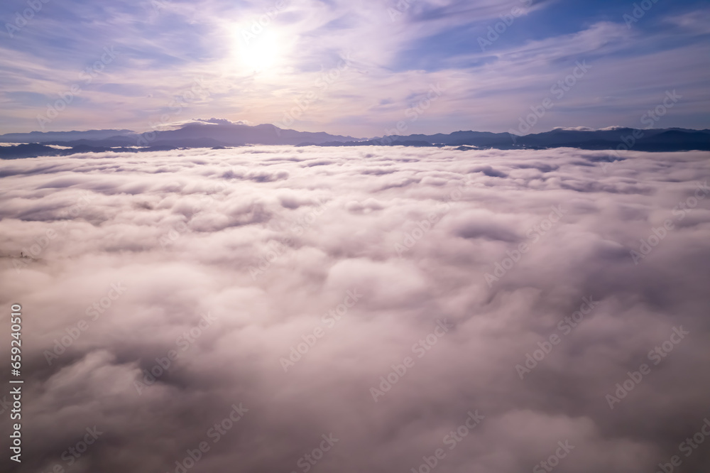 Amazing Sunrise or sunset over mountains hills covered with mist, Aerial view landscape drone shot beautiful colorful nature background