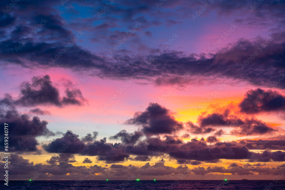 Obraz premium Landscape colorful clouds in the sky sunset or sunrise over sea with reflection in the tropical sea,Beautiful landscape scenery,Amazing light of nature, Landscape nature background