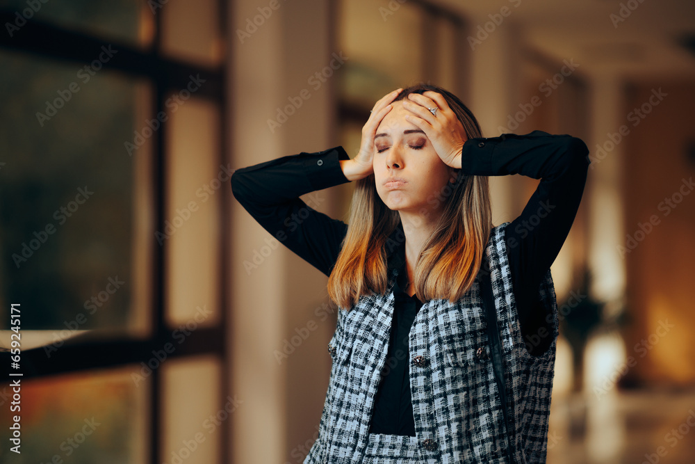 Stressed and Overwhelmed Businesswoman Having a Headache. Desperate office worker feeling overwhelmed and stressed out 

