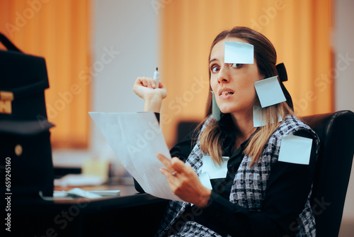 Busy Businesswoman Being Covered in Sticky Notes Working. Stressed office worker using written memos to organize her business strategy 
