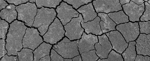Texture soil dry crack background pattern of drought lack of water of nature gray white black old broken.