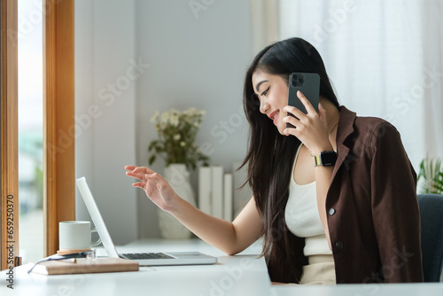 Professional businesswoman having phone conversation with her business partner.