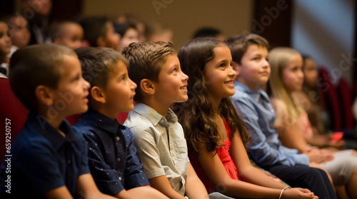 Kids sitting and listen attentively to a speakers talk © AspctStyle