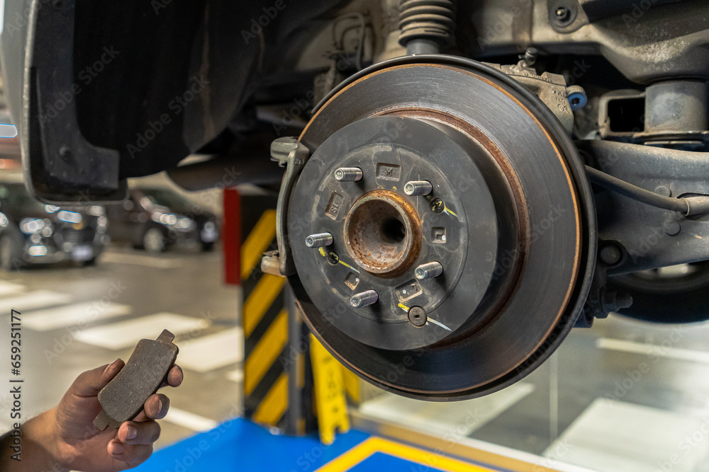 Close up view of a Maintenance Car service - auto oil change, motor check, brake cleaning, tire check, engine inspection, motor oil-brake inspection