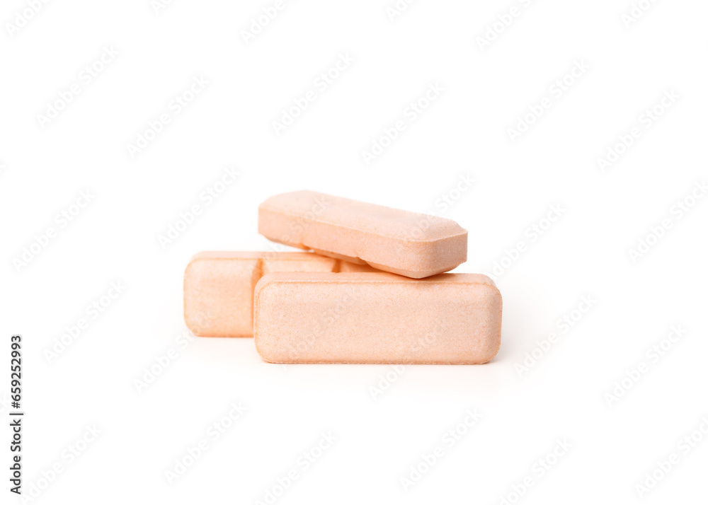 Isolated pile of pills. Multiple rectangular pink tablets. Prescription medicine for cat or dog anxiety. Drug, supplement or painkiller background. White background. Selective focus. Isolated pile of pills. Multiple rectangular pink tablets. Prescription medicine for cat or dog anxiety. Drug, supplement or painkiller background. White background. Selective focus.