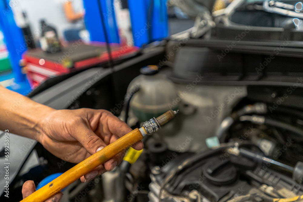 Close up view of a Maintenance Car service - auto oil change, motor check, brake cleaning, tire check, engine inspection, motor oil-brake inspection Close up view of a Maintenance Car service - auto oil change, motor check, brake cleaning, tire check, engine inspection, motor oil-brake inspection