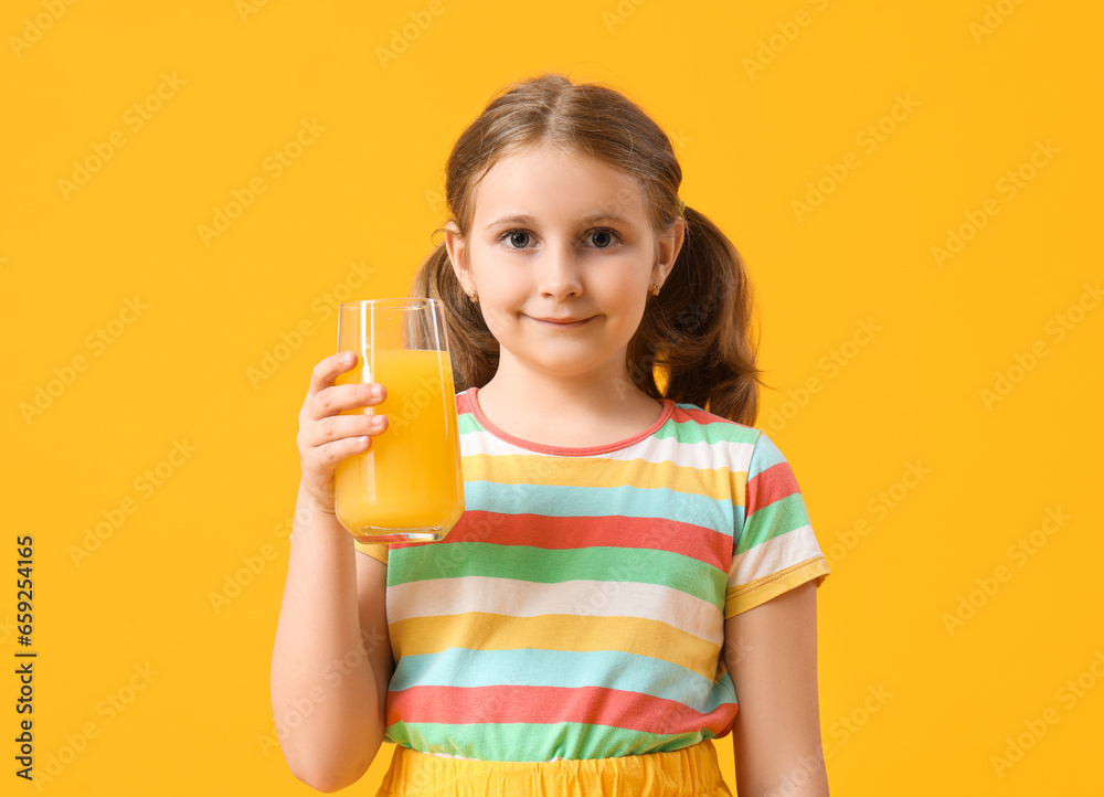 Cute little girl with glass of orange juice on yellow background Cute little girl with glass of orange juice on yellow background