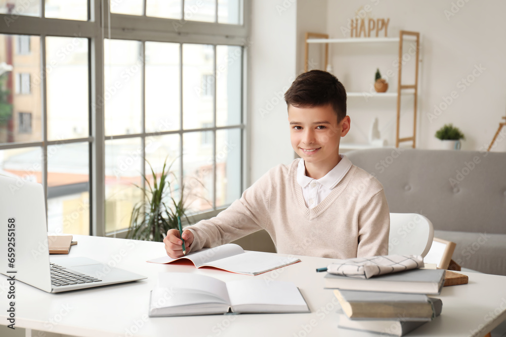 Little boy studying online with laptop at home Little boy studying online with laptop at home