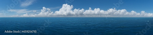 White cumulus clouds above blue Ocean