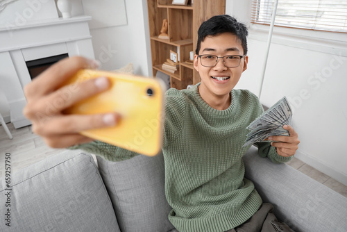 Happy young asian man takin...