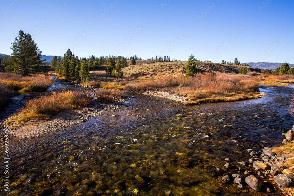Landscape at the confluence of two clear water streams in autumn