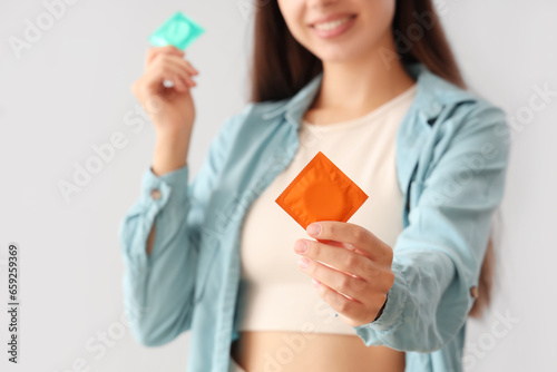 Young woman with condoms on...