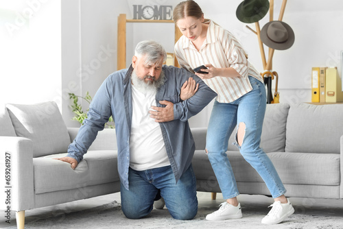 Young woman calling ambulan...