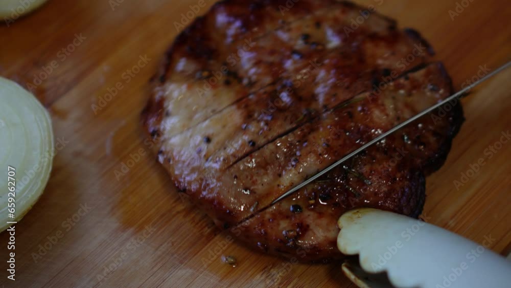 This video shows a chef demonstrating how to cut a grilled pork steak
