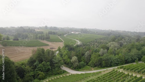 Aerial Shot Of a Small Village in Countryside Surrounded by Vineyard and Farmland photo