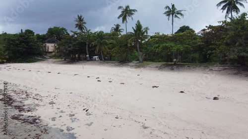 Former Bantigue Cove Beach resort and dive Shop on Malapascua Island empty and abandoned with hilltop Mansion in Background. Aerial photo