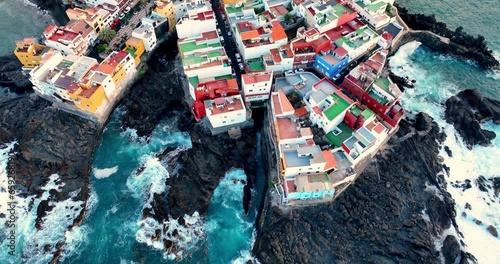 Beautiful aerial view of island Tenerife Spain, Canary Islands. Ocean, sea, city, color houses and waves. Amazing landscape on the sunset to Puerto de la cruz