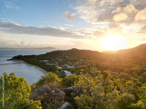 Aerial view on sunset, hills, sea and dock in Picnic Bay, Magnetic Island, Queensland, Australia