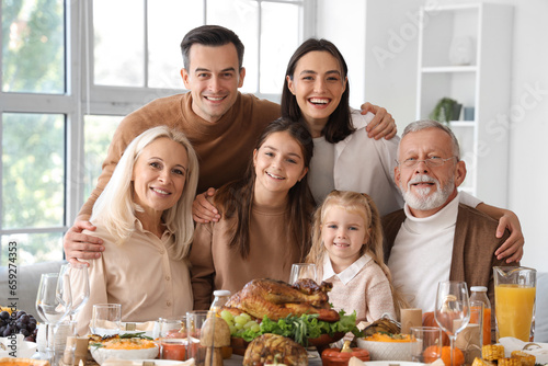 Happy family having dinner at festive table on Thanksgiving Day © Pixel-Shot