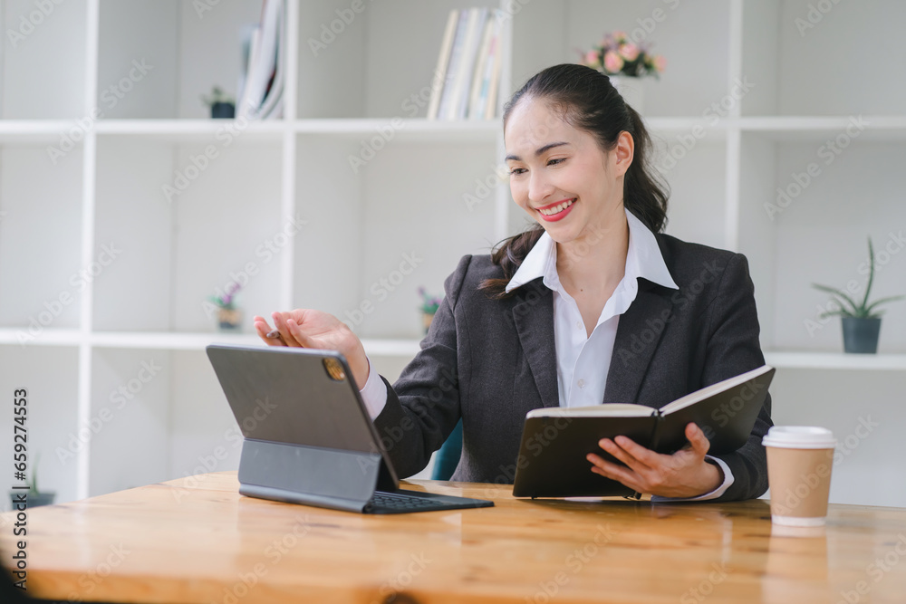 Happy businesswoman using a tablet computer at a cafe. Happy businesswoman using a tablet computer at a cafe.