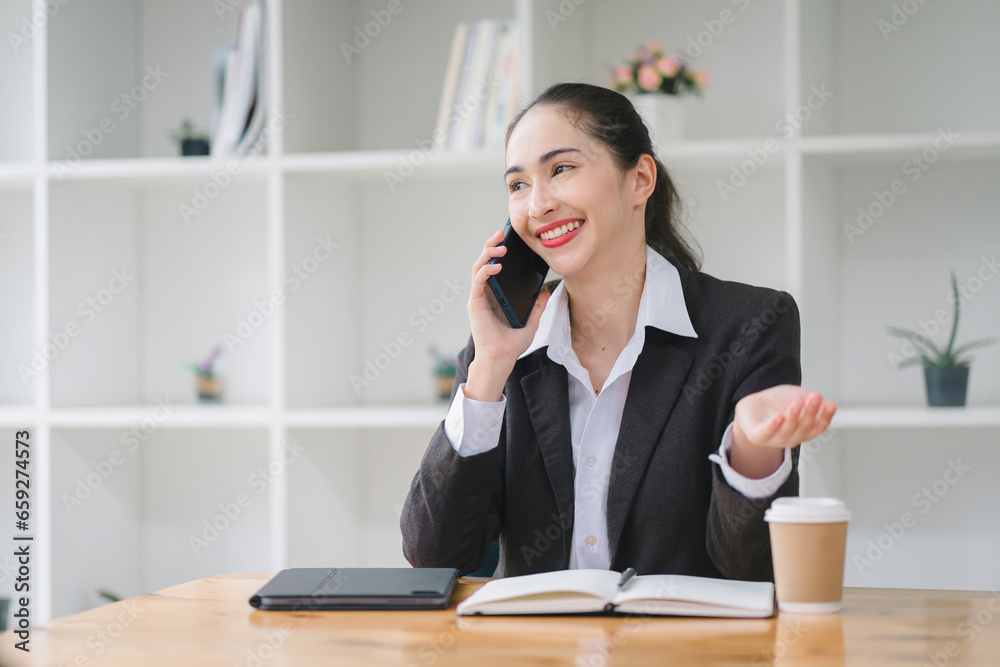 Beautiful young businesswoman enjoying a phone call at a coffee shop. Beautiful young businesswoman enjoying a phone call at a coffee shop.