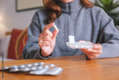 Closeup image of a woman holding pills