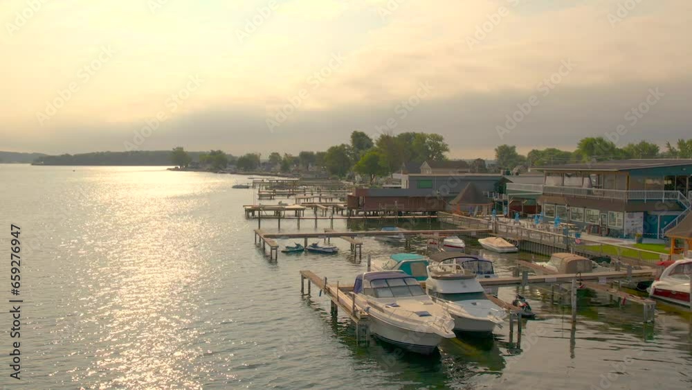 Drone shot of the beach houses, boats docks and restaurant at Sodus point New York vacation spot at the tip of land on the banks of Lake Ontario. Drone shot of the beach houses, boats docks and restaurant at Sodus point New York vacation spot at the tip of land on the banks of Lake Ontario.