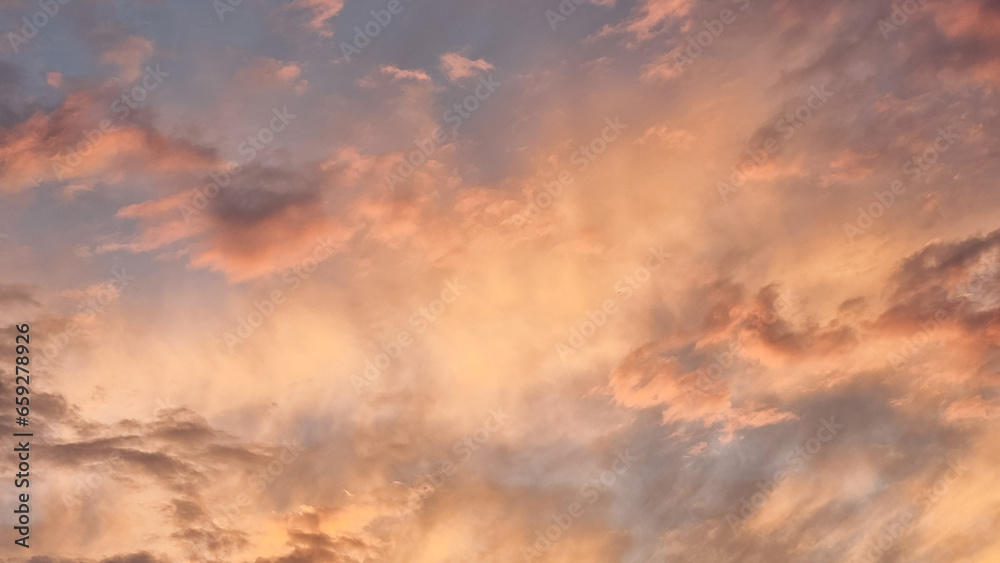 sunset colors on the clouds sky background orange pink