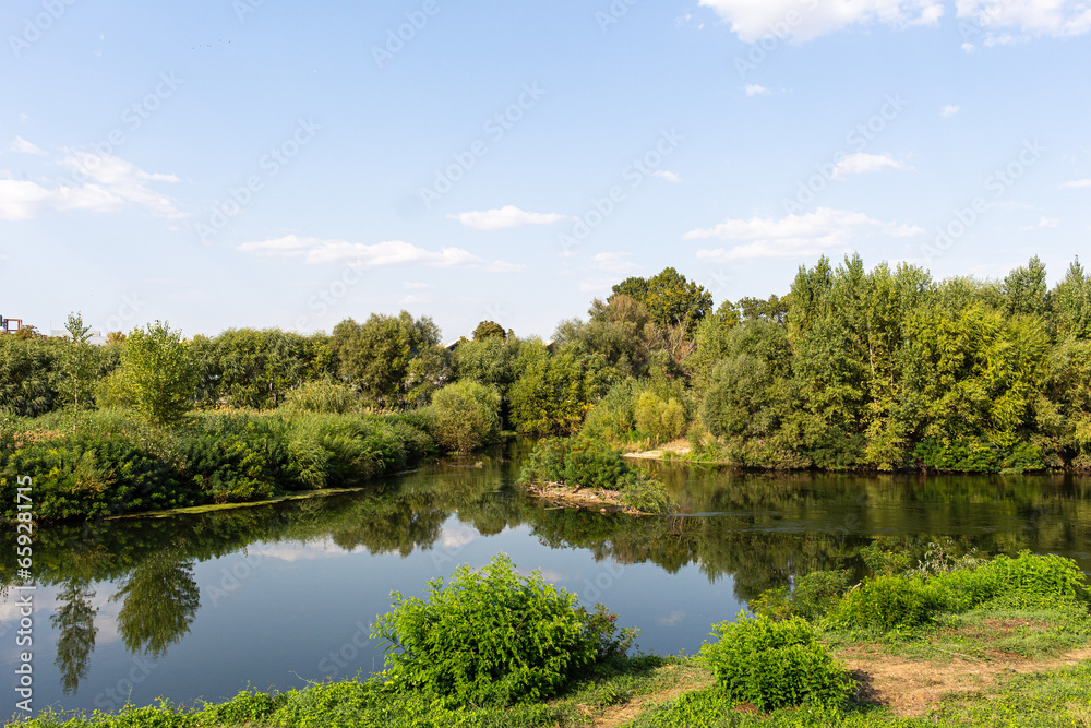 Landscape with river, trees and blue sky Landscape with river, trees and blue sky
