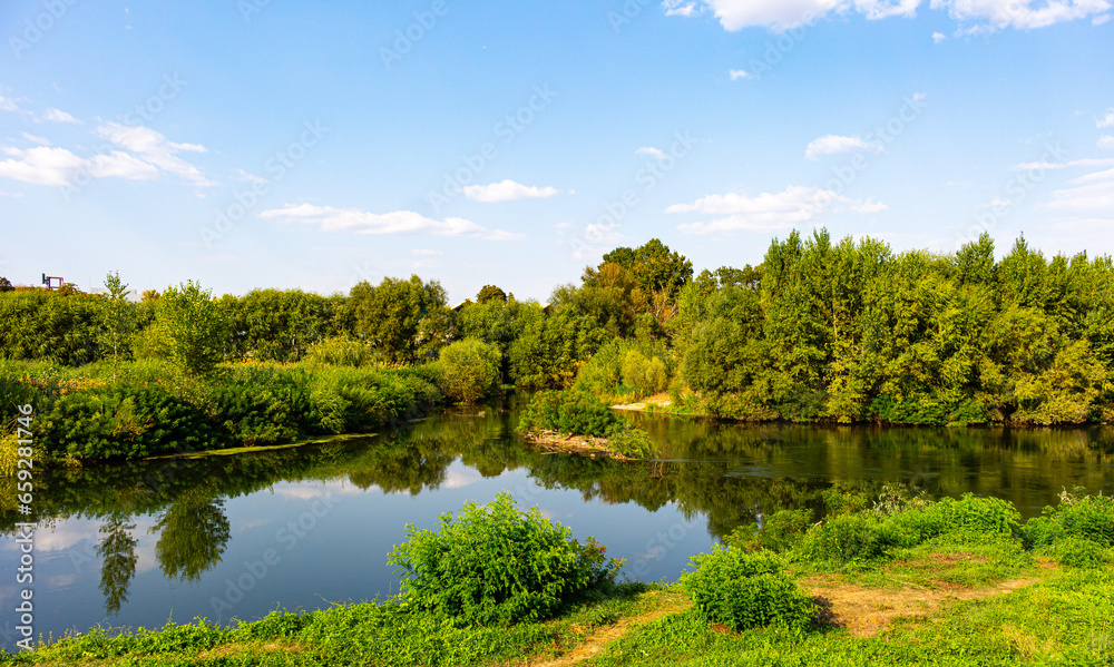 Landscape with river, trees and blue sky Landscape with river, trees and blue sky