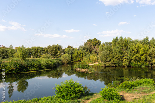 Landscape with river  trees and blue sky