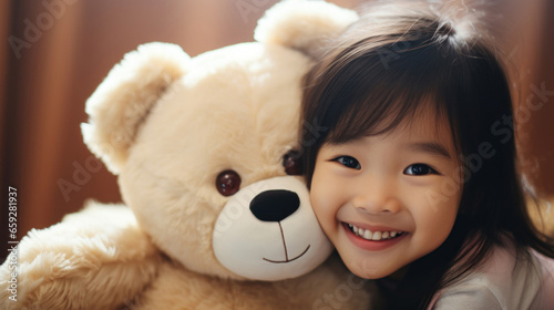 Portrait of a cute Asian girl with a toy © tashechka