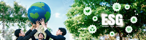 Group of business people promote environment awareness, holding big Earth ball with eco friendly icon symbolize ESG business environmental protection and sustainable net zero effort. Panorama Reliance