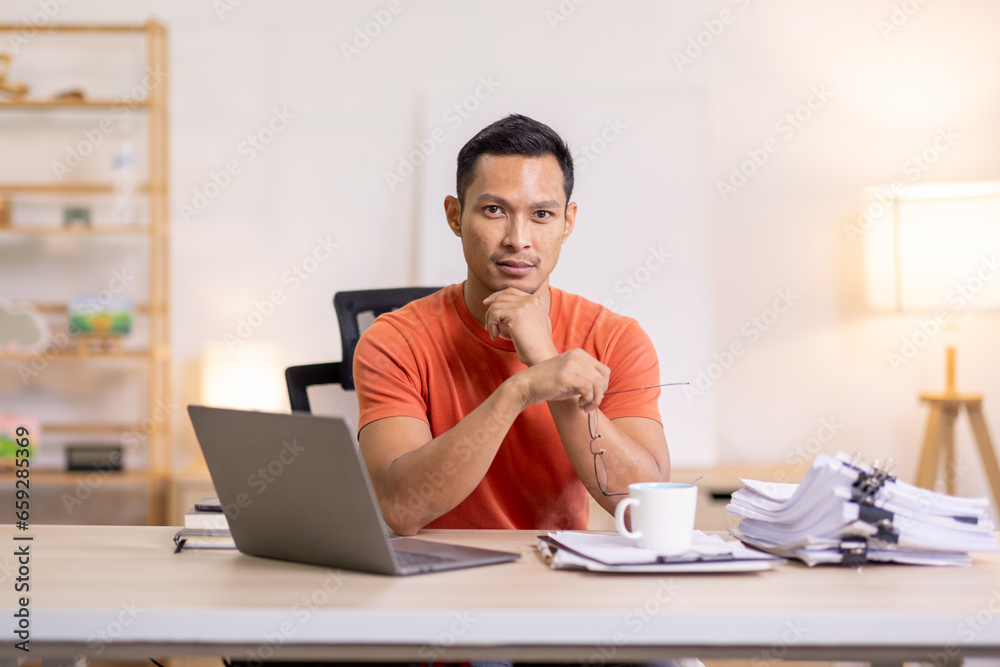 Happy business man work on laptop for email update, online project and reading digital report with mockup space. freelance asian man entrepreneur and working from home research, planning and info Happy business man work on laptop for email update, online project and reading digital report with mockup space. freelance asian man entrepreneur and working from home research, planning and info