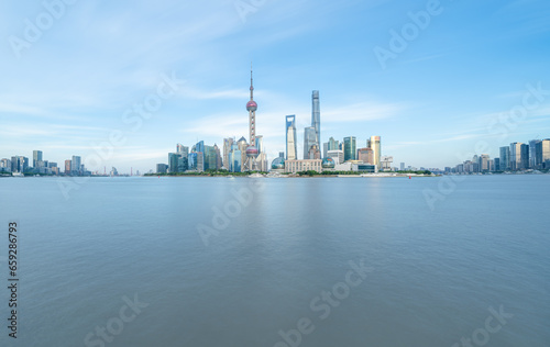 financial district buildings of shanghai and the yacht docked at the dock © shengyi