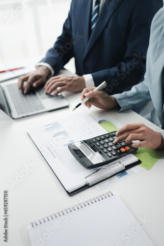 Finance and Marketing Business Meeting, Two businessmen are meeting together and looking at financial and marketing documents to plan how to grow their business. Business meeting concept.