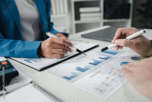 Finance and Marketing Business Meeting, Two businessmen are meeting together and looking at financial and marketing documents to plan how to grow their business. Business meeting concept.