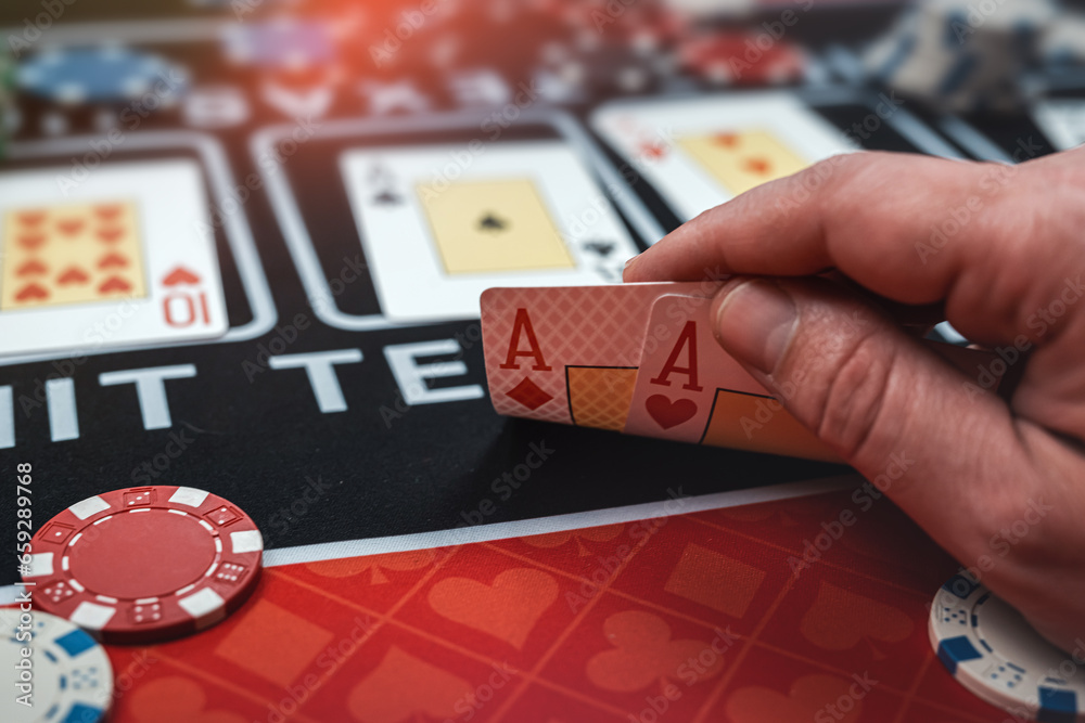 Obraz premium player is holding two ace cards - win combination at poker