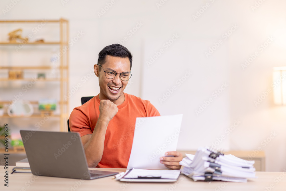 Excited Asian man sit at desk feel euphoric win online lottery, happy asian man overjoyed get mail at laptop being promoted at work, biracial man good news at computer Excited Asian man sit at desk feel euphoric win online lottery, happy asian man overjoyed get mail at laptop being promoted at work, biracial man good news at computer