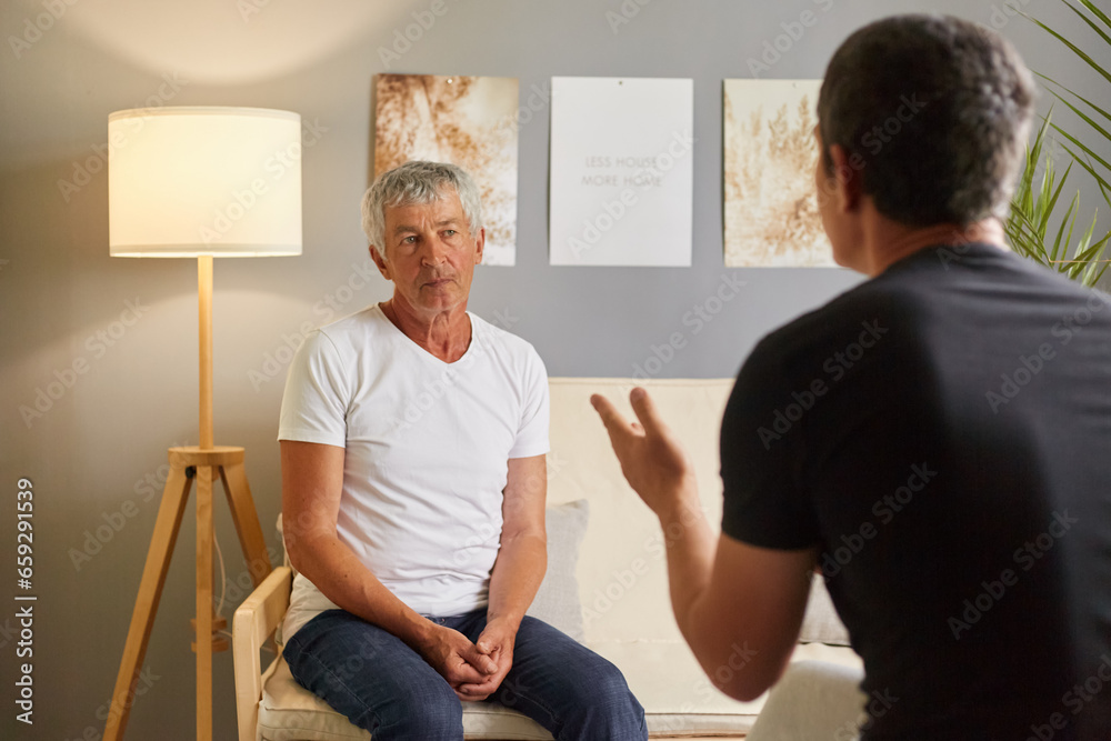 Obraz premium Senior man white T-shirt talking to psychologist at mental health, mature male talking with his son posing backwards about home problems family conflict.