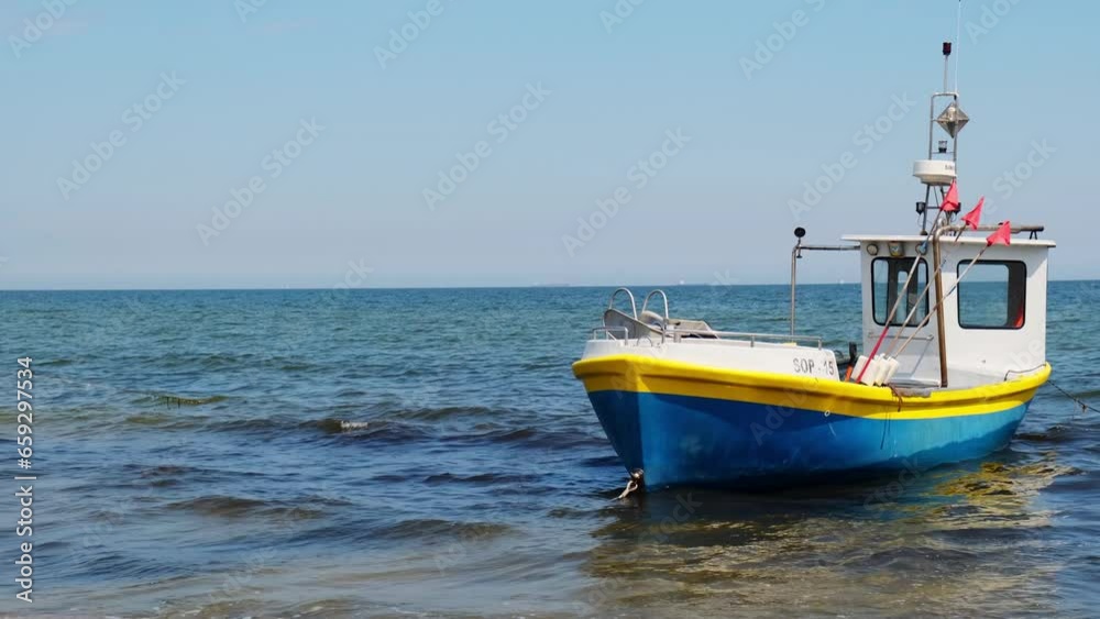 Fishing boat on the beach in Sopot, Poland. Magnificent calm Baltic Sea. Wallpaper defocused waves. Fishermans sea bay Vacation and holidays. travel attraction tourist destination Fishing boat on the beach in Sopot, Poland. Magnificent calm Baltic Sea. Wallpaper defocused waves. Fishermans sea bay Vacation and holidays. travel attraction tourist destination